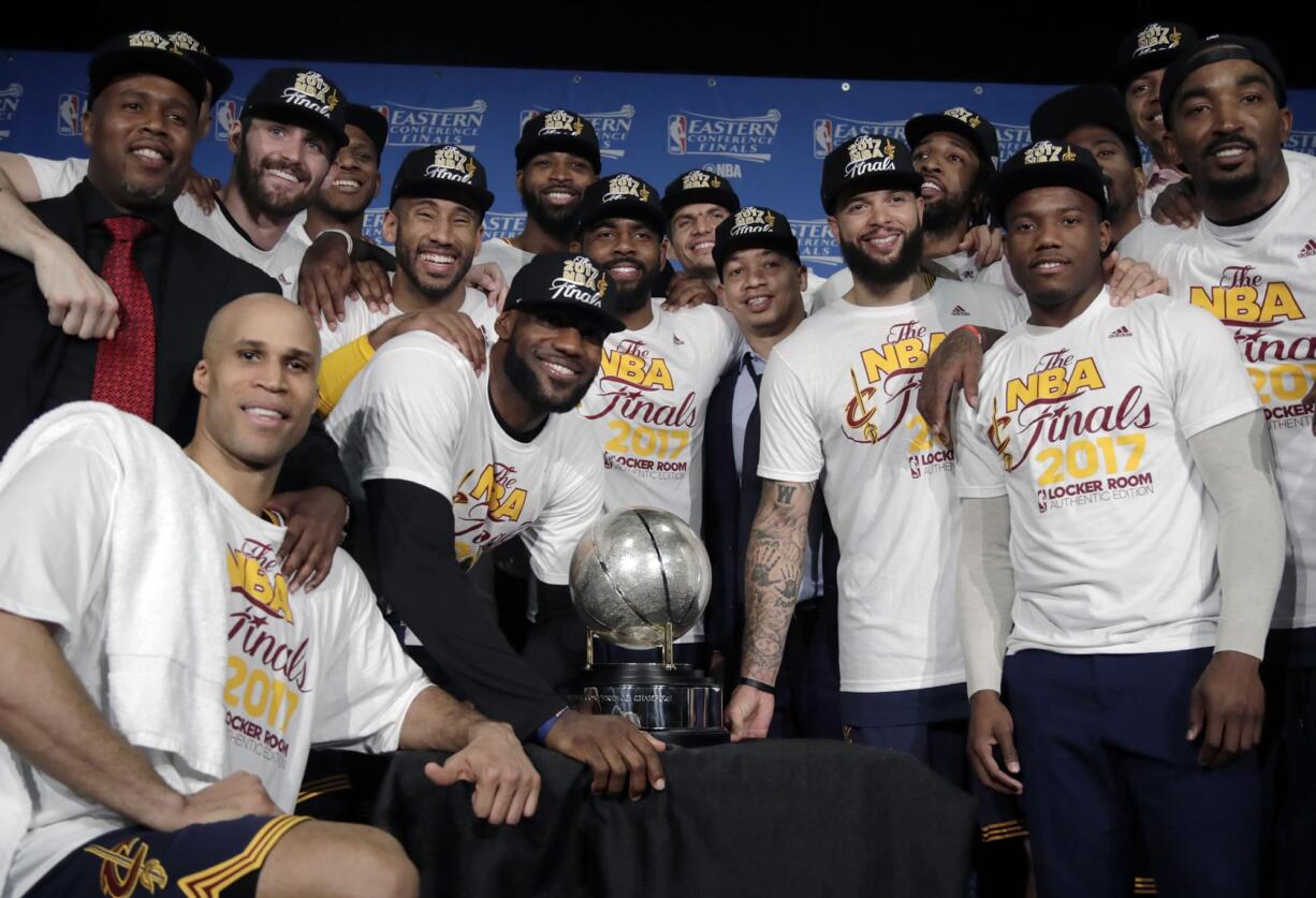 The Cleveland Cavaliers pose with their trophy after winning Game 5 of the NBA basketball Eastern Conference finals against the Boston Celtics 135-102, on Thursday, May 25, 2017, in Boston.