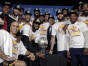 The Cleveland Cavaliers pose with their trophy after winning Game 5 of the NBA basketball Eastern Conference finals against the Boston Celtics 135-102, on Thursday, May 25, 2017, in Boston.