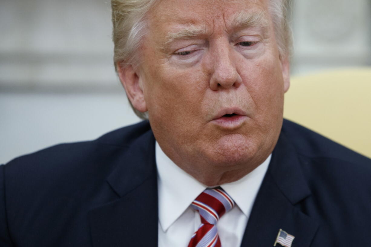 President Donald Trump talks to reporters during a meeting with Dr. Henry Kissinger, former Secretary of State and National Security Advisor under President Richard Nixon, in the Oval Office of the White House on Wednesday in Washington.