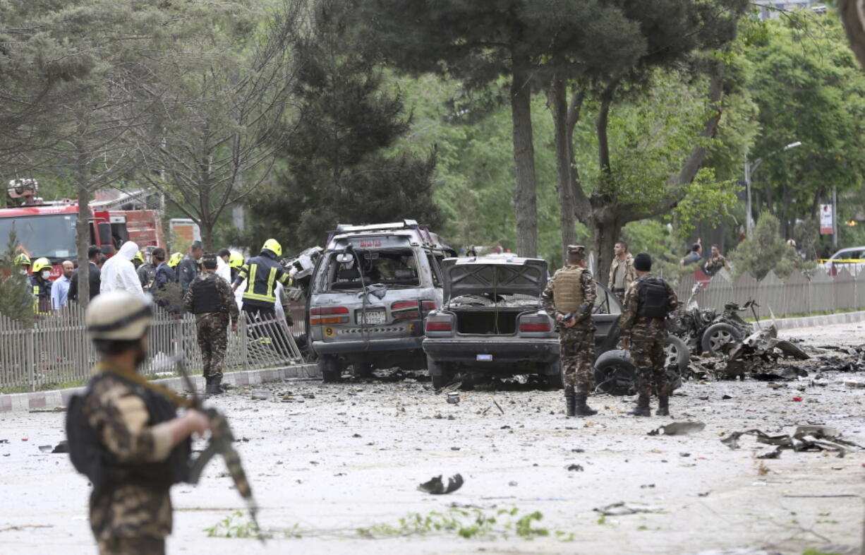 Security forces inspect the site of a suicide attack Wednesday in Kabul, Afghanistan. Afghan officials say that at least four people have been killed in a suicide car bomb attack in the capital Kabul.