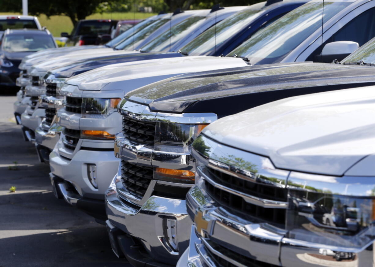 Chevrolet trucks are lined up April 26 at a Chevrolet dealership in Richmond, Va. Analysts expect the auto industry to post a fourth straight month of lower sales as the pace of sales cools after last year&#039;s record.