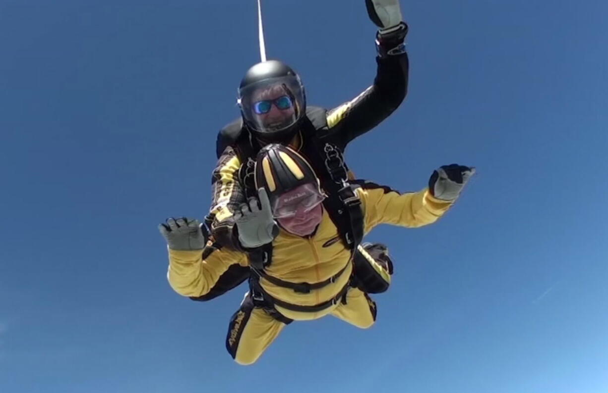 In this grab taken from video, Verdun Hayes gestures as he tandem skydiving, in Devon, England, on Sunday. A 101-year-old D-Day veteran has broken the world record for the oldest tandem skydiver. Hayes, a great-grandfather, jumped out of a plane from 15-thousand feet in Devon, UK, on Sunday accompanied by four generations of his family.