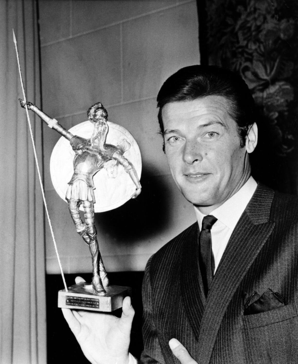 British actor Roger Moore as he poses with Spain’s most prized award, the Don Quixote Award, which was presented to him at the Spanish Embassy in London in 1968. The award, an equivalent to Hollywood’s Oscar, was awarded to him for his role in the British series “The Saint,” one of the most popular shows on Spanish TV.