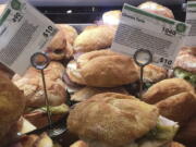 Information cards provide calorie count and price for food items on display at a Whole Foods store, in New York. Calorie counts are already popping up in supermarkets and restaurant chains, despite a delay in a rule requiring them to post the information.