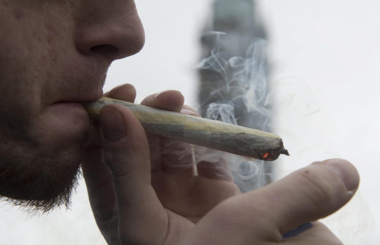 A man lights a marijuana joint as he participates in the annual 4/20 cannabis culture celebration in Ottawa, Ontario.