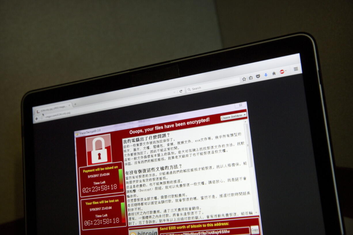 A screenshot of the warning screen from a purported ransomware attack, as captured by a computer user in Taiwan, is seen on laptop in Beijing.