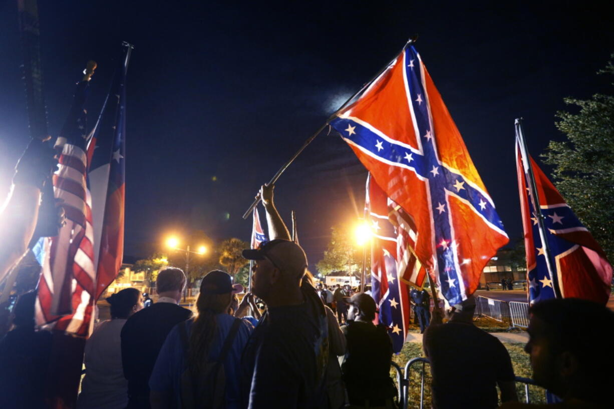 Demonstrators who supports keeping Confederate era monuments protest before the Jefferson Davis statue was taken down in New Orleans on Thursday.