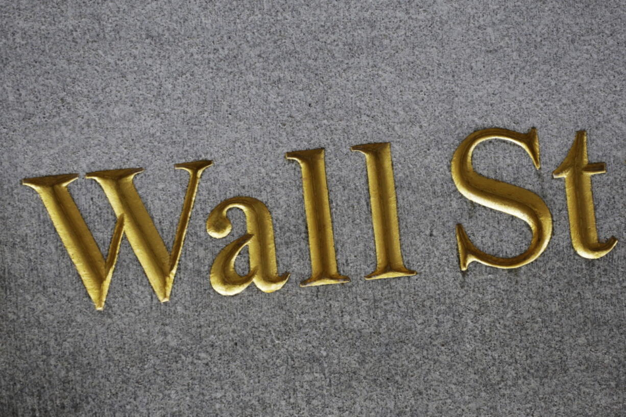 FILE - This Monday, July 6, 2015, file photo shows a sign for Wall Street carved into the side of a building in New York. Stocks are edging higher in early trading on Wall Street, Friday, May 19, 2017, as traders look over a mixed bag of earnings reports.