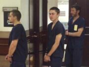 Johnathan Hollis, 19, of Vancouver, center, is escorted, with other inmates, out of the Clark County Courthouse following his first appearance Thursday in Superior Court. Hollis is accused of entering the women's locker room at Vancouver's Firstenburg Community Center and possibly pulling the towel off a woman who was changing.