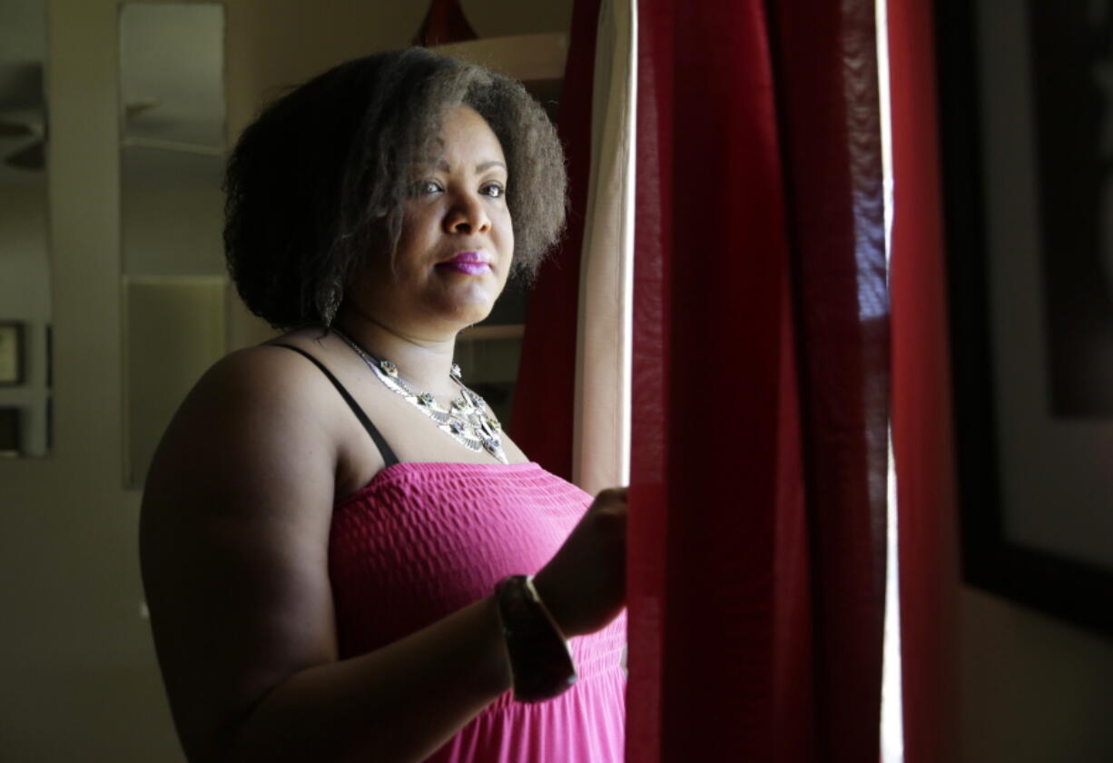 Farah Larrieux poses for a photograph in her home in Miramar, Fla. Larrieux is among roughly 50,000 Haitians legally living and working in the U.S. that could suddenly face deportation if immigration privileges granted after a 2010 earthquake devastated their Caribbean homeland are allowed to expire.