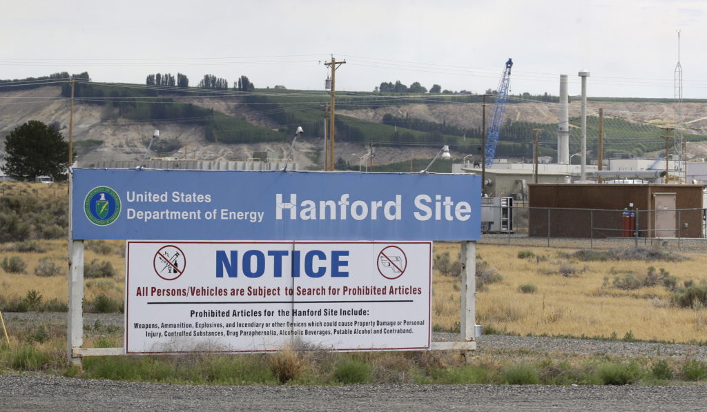 FILE - In this July 9, 2014, file photo, a sign informs visitors of prohibited items on the Hanford Nuclear Reservation near Richland, Wash. A new report says Congress should consider authorizing the Department of Energy to use grout to stabilize some of Hanford's radioactive waste, rather than a more expensive plan to turn it into glass. (AP Photo/Ted S.