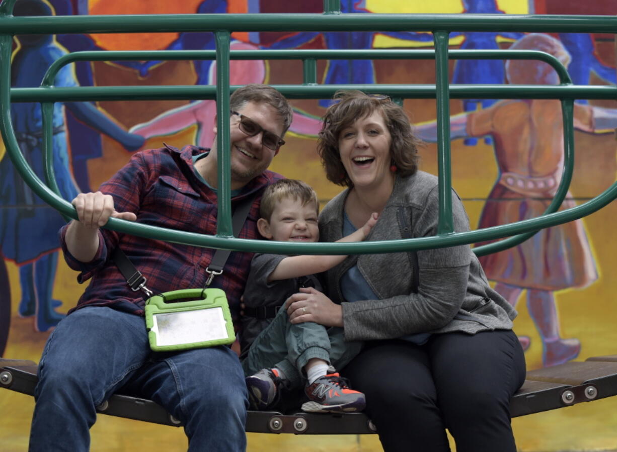 David Rosenblatt, left, 36, a freelance labor researcher, his wife Karen Hoerst, right, 35, a union organizer, and their son Nico, 5, play at Westminster Park in Washington. Nico Rosenblatt cannot speak and struggles to learn because of a rare genetic condition, yet thrives when surrounded by other children in a regular classroom, according to his parents.