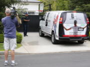 A television cameraman shoots video Wednesday across from the front gate of a home belonging to Cleveland Cavaliers’ LeBron James in Los Angeles. Police are investigating after someone spray-painted a racial slur on the front gate of James’ home in Los Angeles on the eve of the NBA Finals.