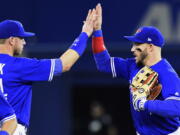 Toronto Blue Jays' Justin Smoak, left, and Steve Pearce celebrate after the Blue Jays defeated the Seattle Mariners 7-2 in a baseball game in Toronto on Thursday, May 11, 2017.