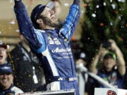 Martin Truex Jr. celebrates in Victory Lane after winning the NASCAR Monster Cup auto race at Kansas Speedway in Kansas City, Kan., Saturday, May 13, 2017. (AP Photo/Colin E.