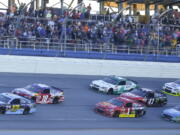 Ricky Stenhouse Jr. (17) leads the pack to finish line for his first Cup win during the Camping World 500 auto race at Talladega Superspeedway, Sunday, May 7, 2017, in Talladega, Ala.