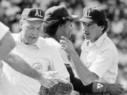 American League umpire Steve Palermo, right, is restrained by California Angels' Rod Carew after he and Angels' Bobby Grich got into an argument in Boston during a game on July 11, 1983. Former big league umpire Palermo, whose accomplished career ended when he was shot trying to break up a robbery in 1991, has died. He was 67.