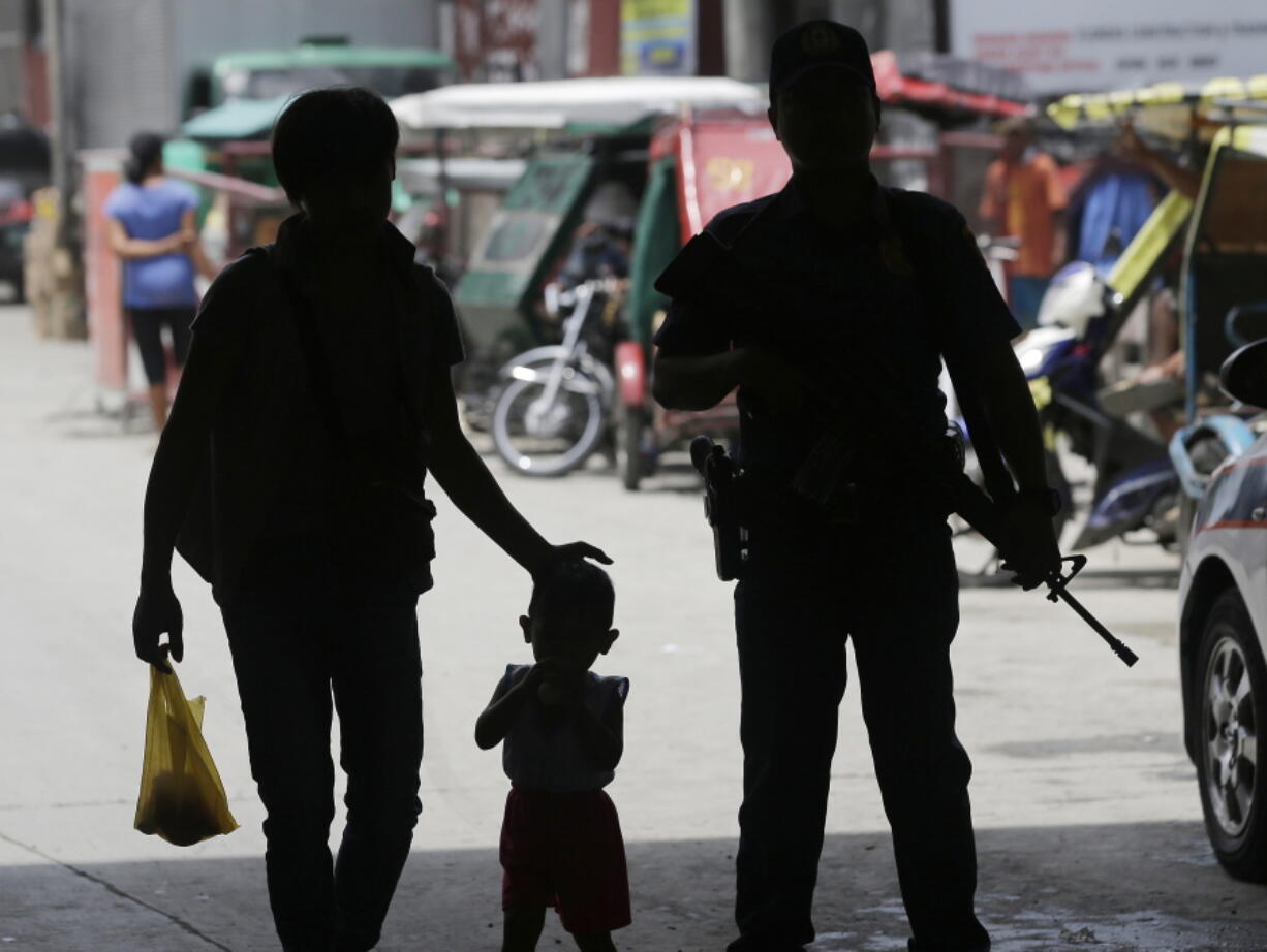 A policeman stands at a checkpoint Wednesday in Manila, Philippines, as the Philippine National Police is placed under full alert status following the declaration of martial law in Mindanao, southern Philippines.