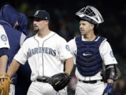 Seattle Mariners closing pitcher Dan Altavilla, left, and catcher Tuffy Gosewisch share congratulations with teammates after the team beat the Texas Rangers in a baseball game Saturday, May 6, 2017, in Seattle. The Mariners won 8-2.