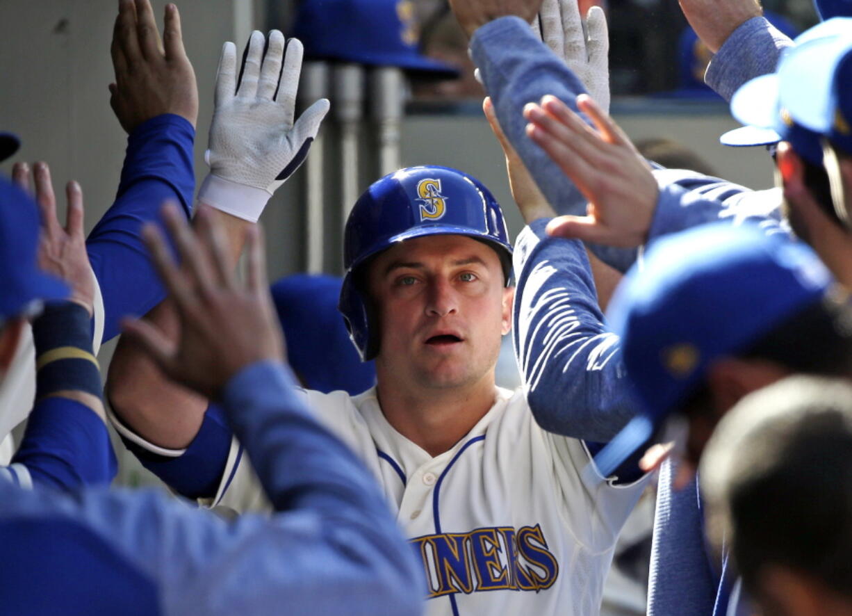 Seattle Mariners&#039; Kyle Seager is congratulated on his solo home run against the Texas Rangers in the eighth inning of a baseball game Sunday, May 7, 2017, in Seattle.