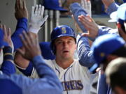 Seattle Mariners&#039; Kyle Seager is congratulated on his solo home run against the Texas Rangers in the eighth inning of a baseball game Sunday, May 7, 2017, in Seattle.