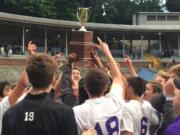 The Columbia River boys soccer team holds the District 4 championship trophy after beating Aberdeen 1-0 on Thursday at Kiggins Bowl.