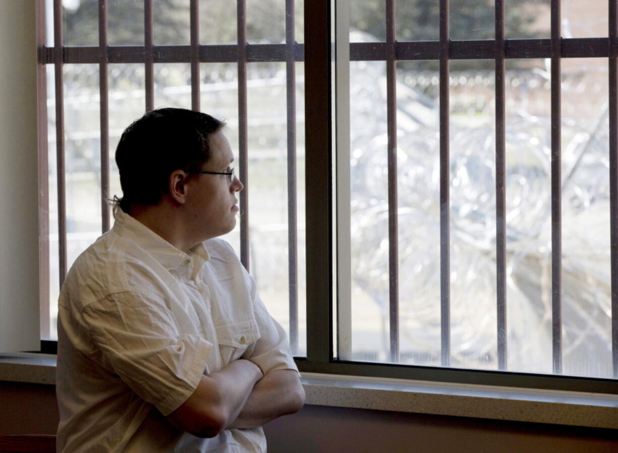 Christopher Lee looks through a window secured by bars towards a barbed wire fence surrounding the building from a conference room at the Minnesota Sex Offender Program in St. Peter, Minn., on March 28. Lee has been in the program since 2005, four days before he turned 19. An ongoing Associated Press investigation has documented how K-12 schools in the United States can fail to protect students in their care from sexual assault, sometimes minimizing or even covering up incidents. Schools also struggle to help sexually aggressive students, both before and after they do lasting harm.