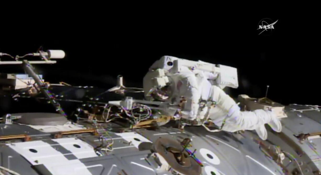 NASA astronaut Jack Fischer works to install antennas at the International Space Station while astronaut Peggy Whitson, not pictured, works on repairs Tuesday.