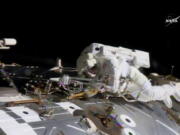 NASA astronaut Jack Fischer works to install antennas at the International Space Station while astronaut Peggy Whitson, not pictured, works on repairs Tuesday.