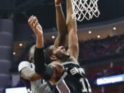 San Antonio Spurs forward LaMarcus Aldridge, right, shoots as Houston Rockets center Clint Capela defends during the second half in Game 6 of an NBA basketball second-round playoff series, Thursday, May 11, 2017, in Houston. San Antonio won 114-75.