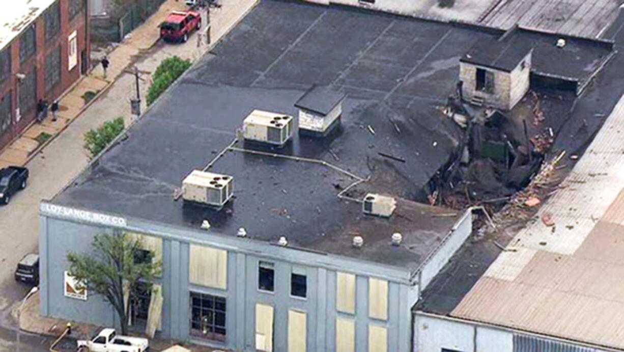 Damage to the roof of the Loy-Lange Box Co. in St. Louis after a steam condensation tank exploded and flew before crashing through the roof of a nearby laundry business. The U.S. Chemical Safety and Hazard Investigation Board released in findings Thursday, May 25, 2017, of its investigation into the explosion that killed several people.