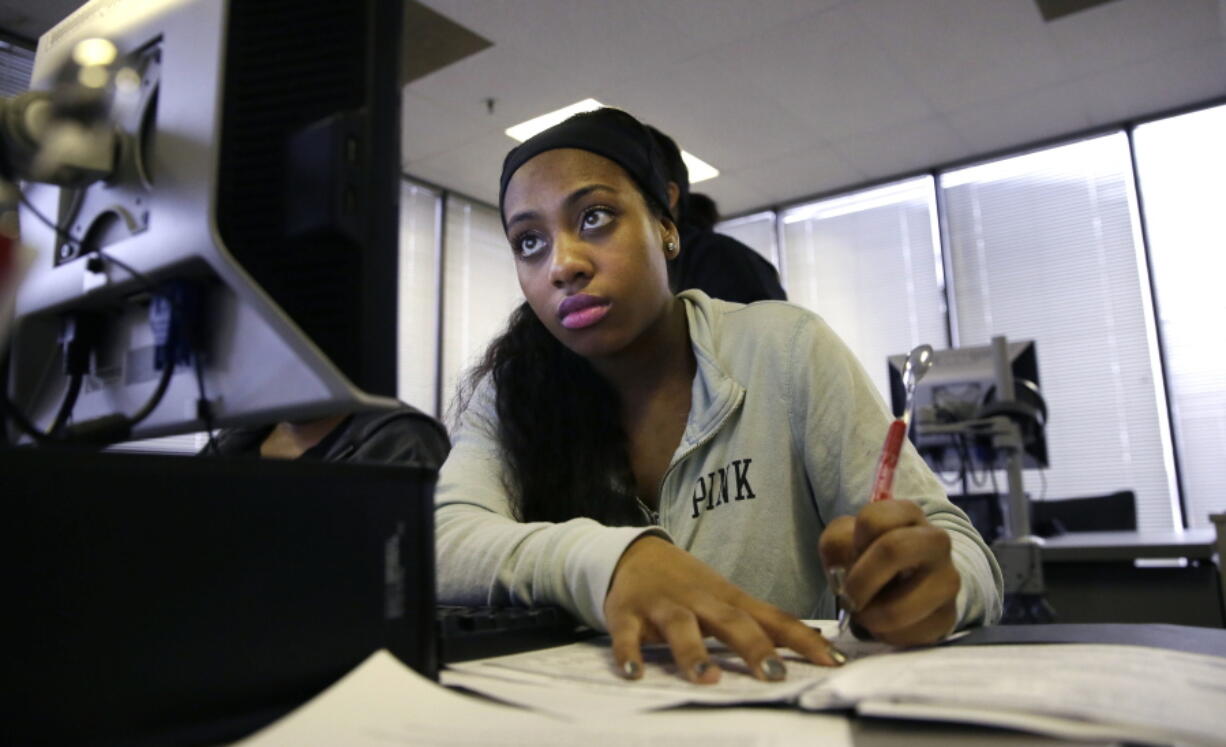 Job seeker Kiana Cupit works on her resume March 10, 2017, during a resume writing class at the Texas Workforce Solutions office in Dallas. Solid hiring nationwide led unemployment rates to touch record lows in three U.S. states last month.