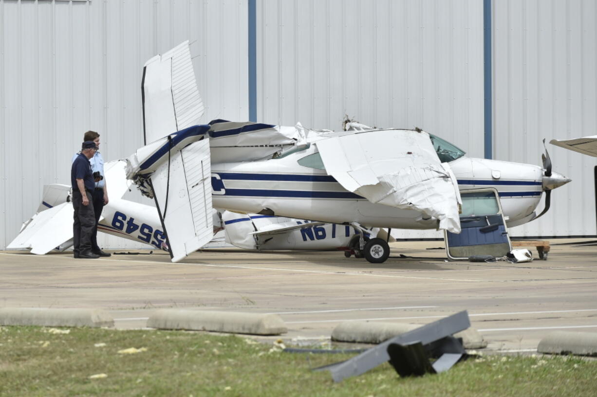 A small plane sustained damage during an overnight storm at Denton Enterprise Airport on Tuesday in Denton, Texas. Authorities say more than a dozen small planes have been damaged as storms packing strong winds struck the North Texas airport.