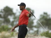 Tiger Woods reacts after a putt during the final round at the Hero World Challenge golf tournament, in Nassau, Bahamas.