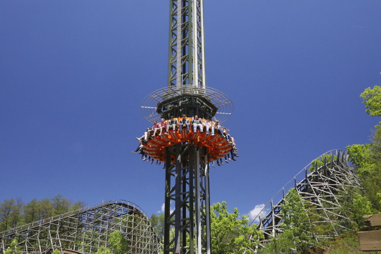 This photo provided by Dollywood in Pigeon Forge, Tenn., shows a new drop tower attraction at the Dollywood theme park. The ride's gondola spins around the tower for a bird's eye view of the Great Smoky Mountains. It's one of a number of new attractions opening at theme parks around the U.S. this spring and summer.