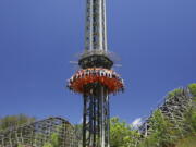 This photo provided by Dollywood in Pigeon Forge, Tenn., shows a new drop tower attraction at the Dollywood theme park. The ride's gondola spins around the tower for a bird's eye view of the Great Smoky Mountains. It's one of a number of new attractions opening at theme parks around the U.S. this spring and summer.