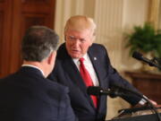 President Donald Trump shakes hands with Colombian President Juan Manuel Santos during a joint news conference in the East Room of the White House in Washington on Thursday.