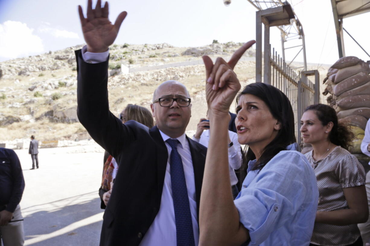 U.S. Ambassador to the U.N. Nikki Haley, right, listens to an official during a visit at the Reyhanli border crossing with Syria, near Hatay, southern Turkey, on Wednesday.