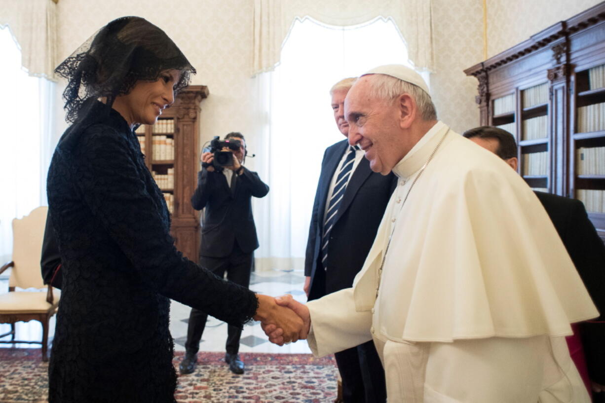 Pope Francis shakes hands with first lady Melania Trump on the occasion of their private audience, at the Vatican on Wednesday.