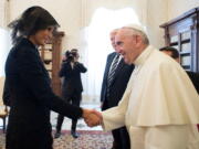 Pope Francis shakes hands with first lady Melania Trump on the occasion of their private audience, at the Vatican on Wednesday.