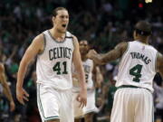 Boston Celtics center Kelly Olynyk (41) celebrates his basket with guard Isaiah Thomas (4) during the fourth quarter of Game 7 of a second-round NBA basketball playoff series against the Washington Wizards, Monday, May 15, 2017, in Boston.