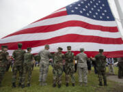 Participants dedicate a new flagpole Monday at Fort Vancouver National Historic Site.