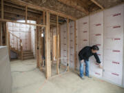 Troy Johns, owner of Urban NW Homes, looks over walls equipped with advance sealing techniques in a three-bedroom home under construction. Johns said he’s finding more homeowners demanding energy-efficient homes.