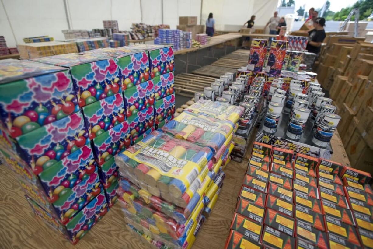 Workers stock a fireworks stand off Northeast Andresen Road prior to its opening in 2011. Fireworks will sold again in most of the county this year, but Vancouver has banned their sale and use.