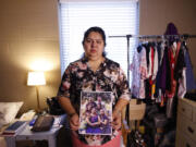 Juana Luz Tobar Ortega holds a photo of her family at St. Barnabas Episcopal Church in Greensboro, N.C. Ortega, who is scheduled for deportation, is taking sanctuary in the Greensboro church.