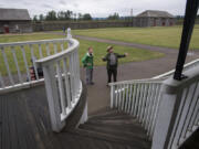 Mikah Meyer, left, 31, who is trying to become the first person to visit all 417 national parks during one road trip, learns about Fort Vancouver National Historic Site during a June 16 tour with Bob Cromwell, chief of interpretation.