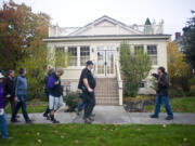 Historian Jeff Davis leads his group past the Red Cross Building in West Vancouver Barracks during a Spirit Tales walking tour in October. Staring Friday, Davis will lead weekend tours through Sept. 4.