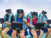 As Kraken speeds through a loop and turns upside down, its riders wearing virtual reality headsets are experiencing an undersea adventure.