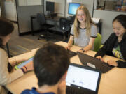 Odyssey Middle School seventh-graders Daisy Gooch, from left, Matthew Houlding, Lauren Mayer and Jace Morik work on presentation projects in class. The Camas School District adopted a new policy that limits the amount of homework teachers can assign students, with the idea that it will make classes more lively and discussion-based as students focus the act of learning instead of spend time finishing homework assignments.