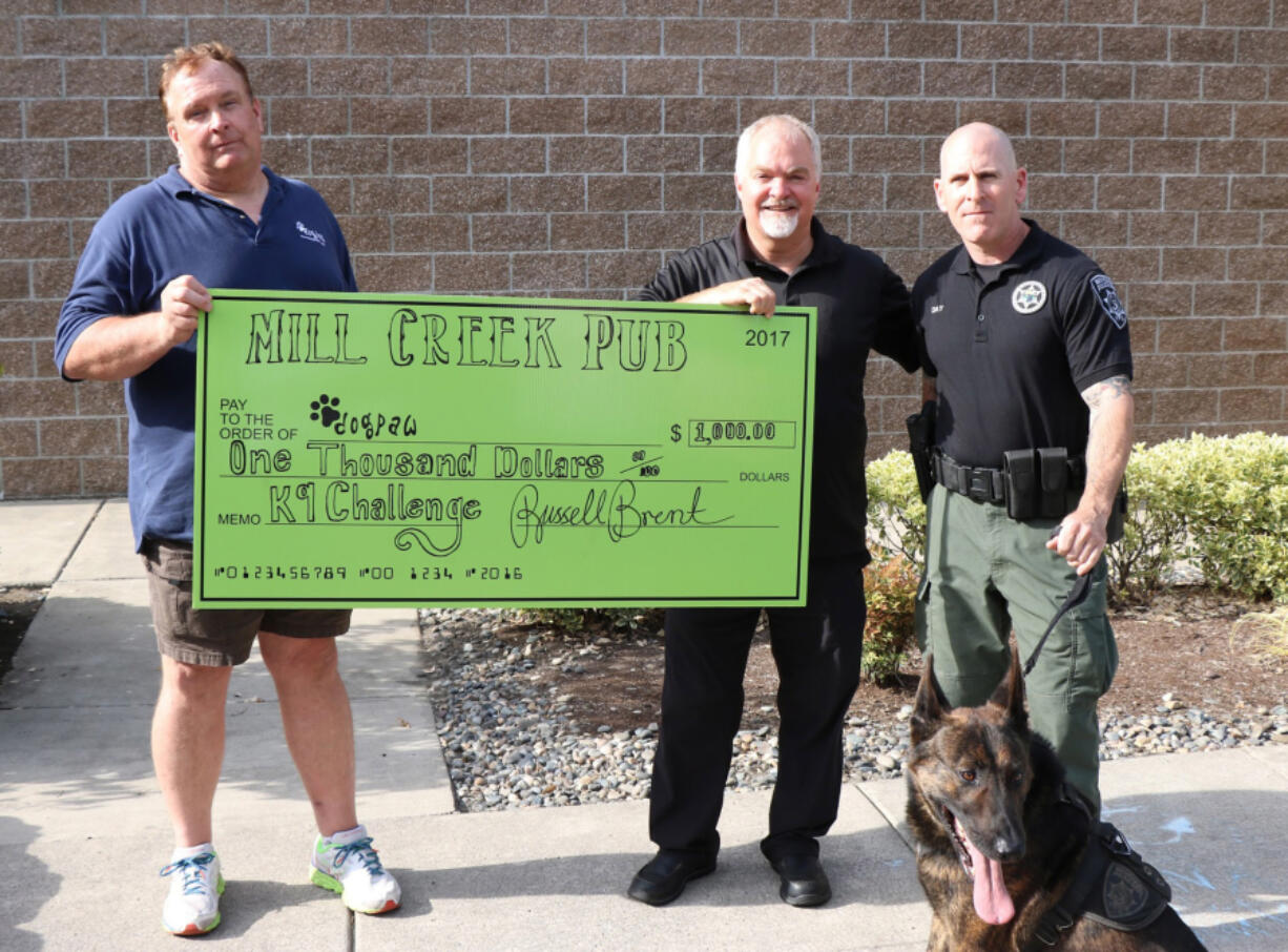 Mill Creek Pub donated $1,000 to DOGPAW to move the nonprofit more than halfway toward its goal of raising $100,000 so it can continue to maintain and operate dog parks around Clark County.